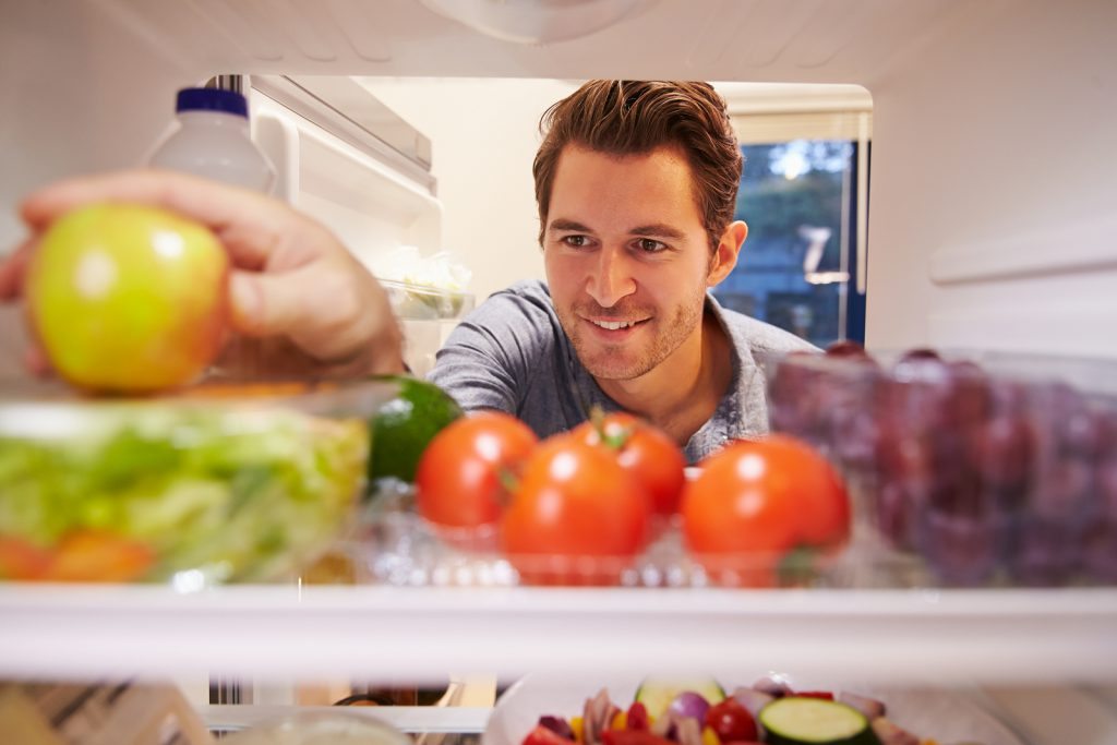 bigstock Man Looking Inside Fridge Full 77371499 1024x683 - 6 Easy Tips for Controlling the Munchies